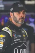  ?? The Associated Press ?? LONG ROAD: Jimmie Johnson looks out from the garage area during practice Saturday for the NASCAR Cup Series race in Long Pond, Pa.