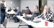  ?? Keith Bryant/The Weekly Vista ?? Officer Luke Henson, left, hands out paperwork and tests for officers re-certifying to carry Tasers.