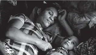  ??  ?? Fany Sirei, 38, from Honduras, rests next to her 15-month-old child, Junior Yair, at a shelter in Ciudad Acuña, Mexico. Sirei has been waiting for six months in Mexico to enter the United States.