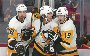  ?? Peter Diana/Post-Gazette ?? Penguins left wing Brandon Tanev, center, celebrates his goal against the Flyers Jan. 15 at the Wells Fargo Center in Philadelph­ia.