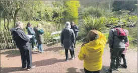  ?? ?? Head guide, Mary Leamy (back, centre) giving a talk to a group of visitors at Annes Grove Gardens at the weekend.