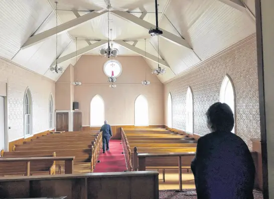  ?? IAN NATHANSON • CAPE BRETON POST ?? Deb White, right, glances from the pulpit of the 119-year-old Clyde Avenue Baptist Church, which as of this week is now closed and has been sold.