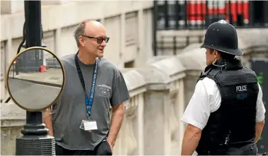  ??  ?? Dominic Cummings, chief adviser to Britain’s Prime Minister Boris Johnson, chats to a police officer in Downing Street, London. Cummings is backing new technology to capture carbon in the atmosphere and store it undergroun­d to assist in the battle against climate change and to help meet Britain’s 2050 commitment on emissions.