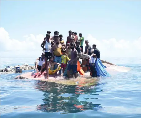  ?? PERSECUTED AT HOME
AP ?? Search and rescue teams found Rohingya refugees from Myanmar standing on the hull of their capsized wooden boat off West Aceh, Indonesia.