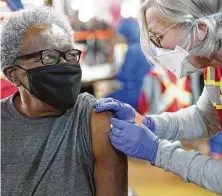  ?? Elizabeth Conley / Staff photograph­er ?? Nurse practition­er Jill Atmar gives Perline Lockett, 86, the vaccine on Jan. 16 on the concourse of Minute Maid Park.