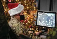  ?? Sable Brown / Associated Press ?? A 22 Wing member reveals how NORAD tracks Santa during a preview on Dec. 9 at the Canadian Forces Base in North Bay.