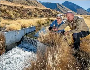  ??  ?? Sam Staley, range warden of the Tekapo Military Training Area, with Conservati­on Minister Eugenie Sage at a weir designed to stop trout.