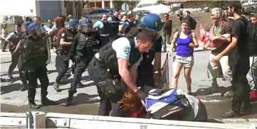  ??  ?? Video grab taken from a footage released and filmed by Italian news video platform Local Team shows French gendarmes clashing with demonstrat­ors taking part in a protest walk to help nearly 30 migrants to cross the border to France. — AFP photo