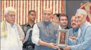  ?? PTI ?? Defence minister Rajnath Singh receives a memento during the 200th anniversar­y celebratio­ns of coronation of Maharaja Gulab Singh, in Jammu on Friday. J&K L-G Manoj Sinha is also seen.