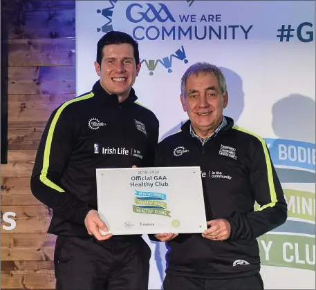  ??  ?? Pat Kelly, representi­ng St Colmcille’s, is presented with the Official Healthy Club Award by Seán Cavanagh, Healthy Clubs Ambassador and former Tyrone footballer. The special ceremony held in Croke Park saw 58 GAA clubs recognised as the first official...