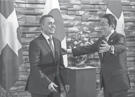  ?? KIMIMASA MAYAMA/POOL VIA AP ?? Swiss President Ignazio Cassis, left, is escorted by Japanese Prime Minister Fumio Kishida before their meeting in Tokyo on Monday.