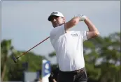  ?? MARTA LAVANDIER — THE ASSOCIATED PRESS ?? Austin Eckroat hits from the 11th tee during the weatherdel­ayed final round of the Cognizant Classic.