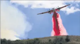  ?? KENT PORTER— THE PRESS DEMOCRAT VIA AP ?? Cal Fire air tankers help stop the spread of a brush fire in Larkfield Calif, Thursday.