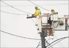  ?? Brian A. Pounds / Hearst Connecticu­t Media ?? A United Iluminatin­g crew repairs wires downed by the storm on Admiral Street and Iranistan Avenue in Bridgeport in 2013.