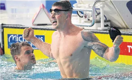  ?? AFP ?? Adam Peaty celebrates winning gold in the men’s 100m breaststro­ke final.