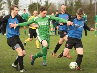  ??  ?? Jack Tobin of Kiltealy Celtic finds a gap between Dominic Maher and Colm Cosgrave of Killenagh.