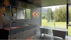  ?? PATRICK REYNOLDS ?? Left, Michelle Quinn won the NKBA Supreme Bathroom of the Year Award with this en suite in a Waimairi, Christchur­ch, home and, right, a dark bathroom for a dramatic house. This master en suite bathroom in Arrowtown is by RTA Studio.