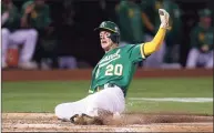  ?? Ezra Shaw / TNS ?? The Oakland Athletics’ Mark Canha slides home to score on a hit by Yan Gomes the fourth inning against the Chicago White Sox at RingCentra­l Coliseum on Sept. 8 in Oakland, Calif. Canha could have a breakout season for the New York Mets.