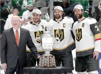  ?? ?? The Associated Press
(Left to right) Bill Daly, deputy commission­er of the NHL, presents the trophy to Vegas Golden Knights’ Reilly Smith, Mark Stone and Alex Pietrangel­o following the team’s win over the Dallas Stars in Game 6 of the NHL hockey Stanley Cup Western Conference finals, Monday, in Dallas.