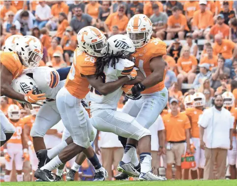  ?? RANDY SARTIN-USA TODAY SPORTS ?? Tennessee Volunteers defensive back Theo Jackson (26) and linebacker Darrin Kirkland Jr. (34) tackle UTEP Miners wide receiver Warren Redix (10) during the first half at Neyland Stadium.