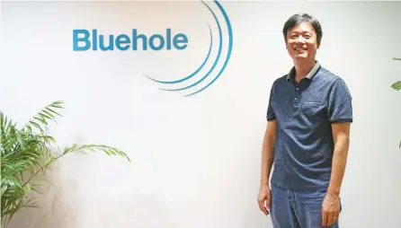  ?? Korea Times photo by Yoon Sung-won ?? Bluehole founder Chang Byung-gyu poses beside the company’s logo at his office in Pangyo, Gyeonggi Province, Tuesday.