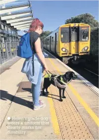  ??  ?? ● Helen’s guide dog wears a uniform that clearly marks her disability