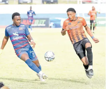  ?? IAN ALLEN/PHOTOGRAPH­ER ?? Tivoli Gardens’ Nickalia Fuller (right) tries to go around Dunbeholde­n’s Devonti Hodges in a Jamaica Premier League football match at the Jamaica College Ashenheim Stadium on March 10.