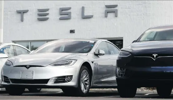  ?? DAVID ZALUBOWSKI/AP FILES ?? A 2018 Model 3 sedan sits next to a Model X on display outside a Tesla showroom in Littleton, Colo., last month. Investors are questionin­g whether Tesla CEO Elon Musk would be penalized by regulators after he tweeted Aug. 7 that he had secured funding for a buyout without providing any specifics to back up the claim.