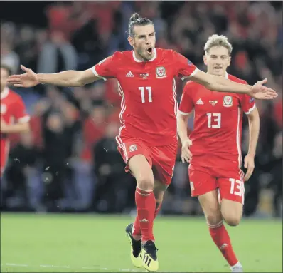  ?? PICTURE: MIKE EGERTON/PA ?? Gareth Bale roars his delight after netting as Wales romped to an emphatic 4-1 UEFA Nations League win over the Republic of Ireland at Cardiff City Stadium last night. Match report: Page 24. CELEBRATIO­NS: