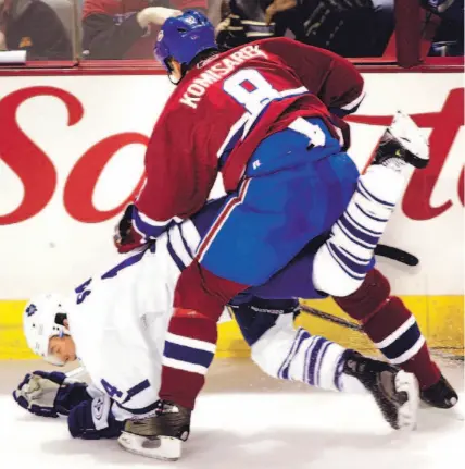  ?? CHRISTINNE MUSCHI/ CP ?? Canadiens defenceman Mike Komisarek gives the Leafs’ Matt Stajan a rough ride during first-period action last night in Montreal.