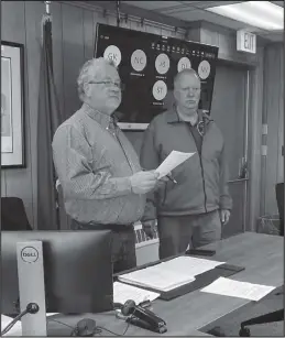  ?? Photo by Diana Haecker ?? RECOGNITIO­N— Mayor John Handeland reads the resolution honoring Tom Vaden for his long years of service to the NVAD.