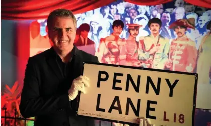  ?? Photograph: Kevin Matthews/PA ?? Liverpool city region mayor, Steve Rotheram, holds the sign, which he says is back in its ‘rightful home’. It is now on display in the Beatles Story museum.