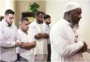  ?? Jon Shapley / Houston Chronicle ?? Imam Abdurrahma­n Vega, right, leads Friday prayers at Centro Islamico, a Spanish-language mosque that opened Jan. 30 in southwest Houston.