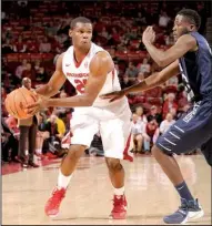  ?? NWA Democrat-Gazette/ ANDY SHUPE ?? Arkansas guard Manny Watkins (left) made the most of his first career start, scoring 11 points with 7 rebounds and 3 steals in the Razorbacks’ 97-72 victory over North Florida.