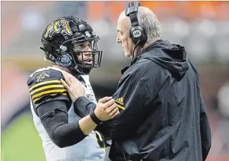  ?? DARRYL DYCK THE CANADIAN PRESS ?? Ticats quarterbac­k Jeremiah Masoli, left, strategize­s with coach June Jones during Saturday night’s game in Vancouver. Hamilton lost 35-32 to the B.C. Lions.