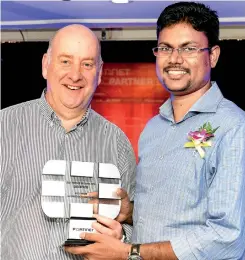  ??  ?? Viraj De Mendis, Senior Consulting Engineer, Millennium Informatio­n Technologi­es, receiving the Best Partner 2016 award for Sri Lanka from Darren Turnbull, Vice President Strategic Solutions at Fortinet