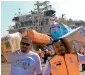  ?? AFP ?? Malaysian workers unload relief aid boxes for Rohingya Muslims, delivered by the humanitari­an aid Malaysian ship Nautical Aliya at Chittagong port. —