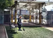  ?? ?? Rachel Niebur sits with her dog, Petey, at a small dog park in a former city bus depot now within the nonprofit People Assisting the Homeless, in the Venice section of Los Angeles on April 5.