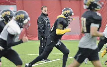  ?? PHOTOGRAPH BY BARRY GRAY, THE HAMILTON SPECTATOR ?? St. Thomas More senior boys football head coach Claudio Silvestri watches as the team prepares for the upcoming OFSAA game in Ottawa on Monday.