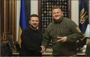  ?? (AP/Ukrainian Presidenti­al Press Office) ?? Ukrainian President Volodymyr Zelenskyy (left) shakes hand with Gen. Valerii Zaluzhnyi, outgoing commander in chief of Ukraine’s armed forces, during their meeting in Kyiv, Ukraine, on Thursday.