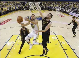  ?? AP Photo/Marcio Jose Sanchez ?? ■ Golden State Warriors' Stephen Curry (30) drives to the basket as Cleveland Cavaliers' Kevin Love (0) defends during the second half of Game 1 of basketball's NBA Finals Thursda in Oakland, Calif.