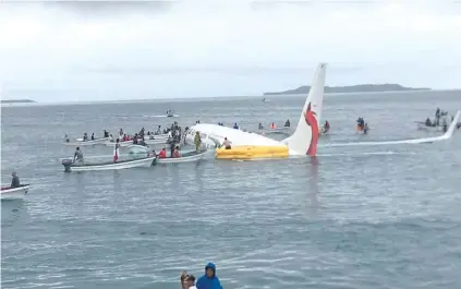  ?? — Reuters ?? Locals scrambling in small boats to rescue the passengers and crew.