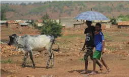  ?? (Tiksa Negeri/Reuters) ?? ERITREAN REFUGEE CHILDREN walk outside of the Adi Harush Refugee camp in Ethiopia’s Tigray region last month.