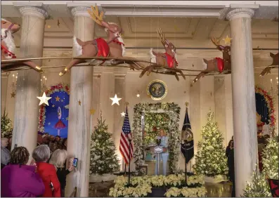  ?? (AP/Jacquelyn Martin) ?? Underneath papier-mache reindeer, first lady Jill Biden speaks Monday during the unveiling of the White House holiday decoration­s in the Grand Foyer of the White House in Washington.