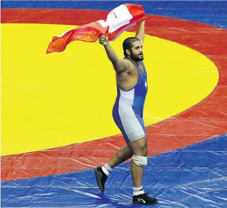  ?? CAMERON SPENCER / GETTY IMAGES FILE ?? Arjan Bhullar celebrates winning the 120-kg freestyle wrestling gold at the 2010 Commonweal­th Games.