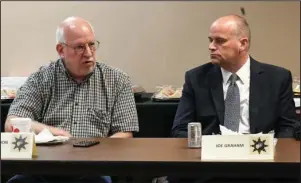  ?? The Sentinel-Record/Grace Brown ?? MENTAL HEALTH TALK: Dr. Robert Gershon, left, CEO and executive director of Ouachita Behavioral Health & Wellness, discusses mental health issues as Garland County District Court Judge Joe Graham listens Wednesday during a roundtable discussion of public officials and community leaders held at the Hot Springs Police Department.
