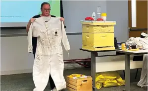  ?? (Staff photo by Karl Richter) ?? Heather Mcbride, an Advanced Beekeeper in the Texas Master Beekeeping Program, displays a protective suit during a presentati­on titled Getting Started With Honeybees on Monday at Texas A and M University-texarkana in Texarkana, Texas. Bowie County Master Gardeners and TAMUT’S Extended Education and Community Developmen­t Department hosted the talk.