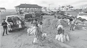  ??  ?? People fill sandbags Tuesday at Long Beach Harbor in Long Beach, Miss., in advance of Tropical Storm Gordon, which is continuing to strengthen and was expected to become a hurricane late Tuesday. AMANDA MCCOY/THE SUN HERALD VIA AP