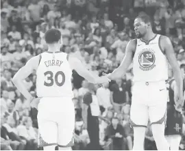  ?? (AP) ?? GOLDEN STATE Warriors guard Stephen Curry (30) reacts with forward Kevin Durant (35) during the first half of Game 1 of a second-round NBA basketball playoff series against the Houston Rockets in Oakland, Calif.