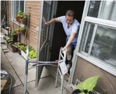  ??  ?? Doan struggles on the stairs. In June, she lost her balance, fell to the landing and cut her head. She uses a walker to tend her garden.